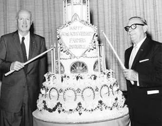 Tyler and Leavey light candles on the 30th Birthday cake.