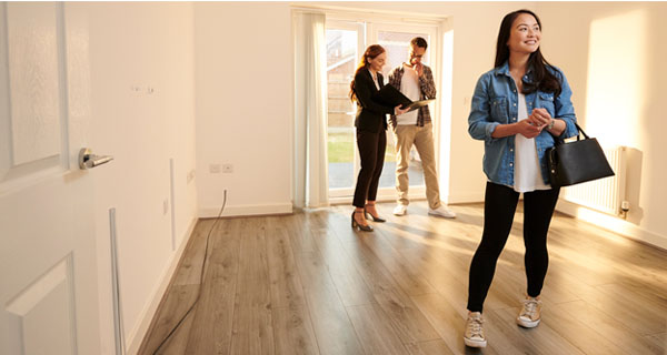 people looking at empty home interior