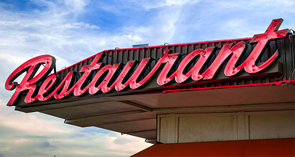 Restaurant sign on roof of building