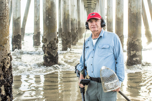 Stan Ross holding detector gear under the pier